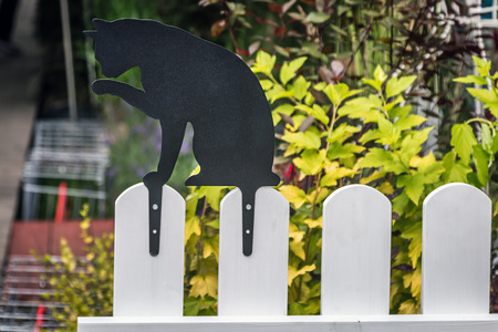 decorative cat on the fence. decorations for garden