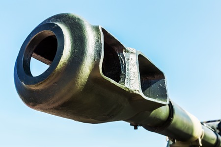 barrel and flame arrestor guns or self-propelled artillery against a blue skyの写真素材