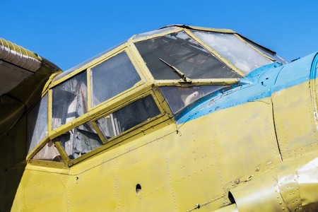 fuselage and cockpit of the airplane against the blue skyの写真素材