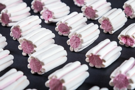 marshmallow pastel shades on black background.marshmallow Colorful pattern on pink pastel background and copy spaceの写真素材