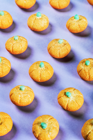 marshmallows in the shape of a pumpkin for the holiday Halloween on a purple background. pastel...