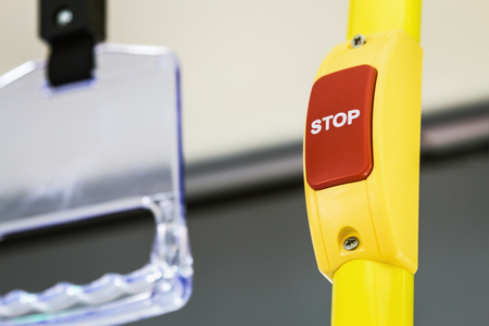 stop button modern and comfortable interior of the city bus. There is a dedicated Braille