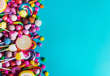 sweets, lollipop, chewing gum, candies etc on blue backgroundの写真素材