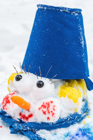 Funny snowman made of fallen snow in the winter Park. Merry Christmas and happy New year!の写真素材