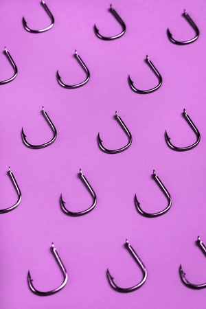 lots of fishing hooks on purple background. fishing accessories and accessoriesの写真素材
