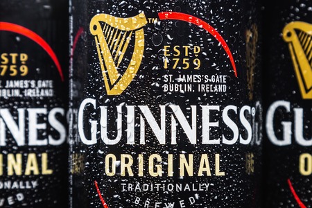 Moscow, Russia - March 28, 2019: logo on aluminum cans of Guinness beer. Guinness beer brand, originally belonged to the Irish company Arthur Guinness Son Co, founded in 1759 by the brewer Arthur Guinnessのeditorial素材