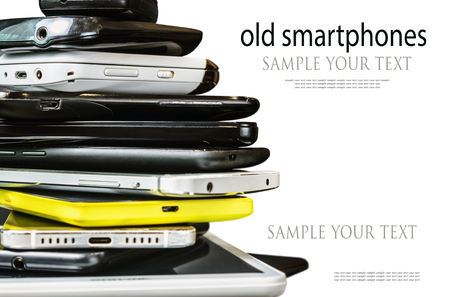old and broken smartphones and mobile phones isolated on white background. Text deleteの写真素材