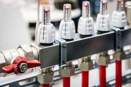 fittings and valve, pipes and adapters. Plumbing fixtures and piping parts. focus on the red craneの写真素材