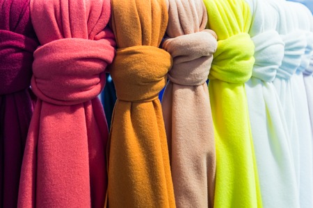 scarves of different colors on the counter in the storeの写真素材