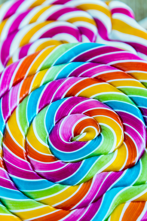striped spiral multi-color Lollipop closeup. sweets multicolourの写真素材