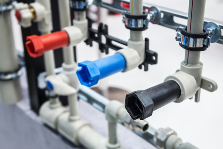 plugs of different colors for cold and hot water in the water supply systemの写真素材