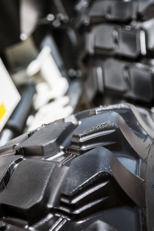 large tires with deep treads mounted on a tractor, dump truck or bulldozerの写真素材