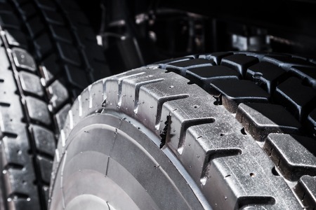 large tires with deep treads mounted on a tractor, dump truck or bulldozerの写真素材