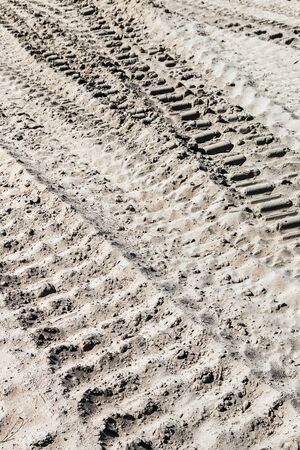 ground and sand and tracks left by tank, tractor or other vehiclesの写真素材