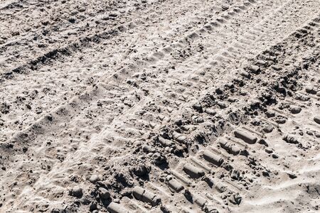 ground and sand and tracks left by tank, tractor or other vehiclesの写真素材