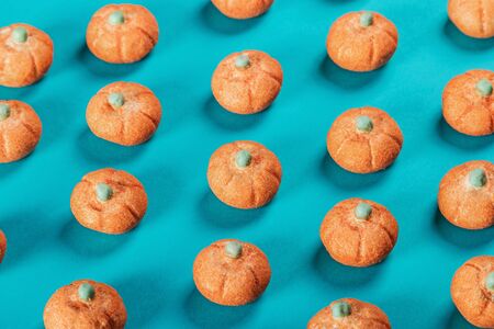 little pumpkins from marshmallow on blue background for Halloweenの写真素材