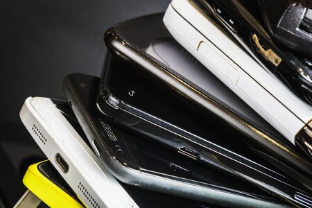 old and broken smartphones and mobile phones. Background of old phones.の写真素材