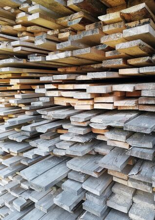 background of sawn boards in a stack. lumber at a sawmill or building materials storeの写真素材