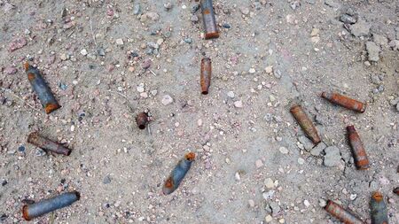 lots of old rusty gun sleeve on the groundの写真素材