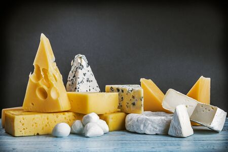 assorted cheeses, soft, hard, rennet and brine on a black backgroundの写真素材