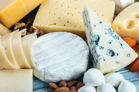 assorted cheeses, soft, hard, rennet and brine with fruits, nuts and dried fruitsの写真素材