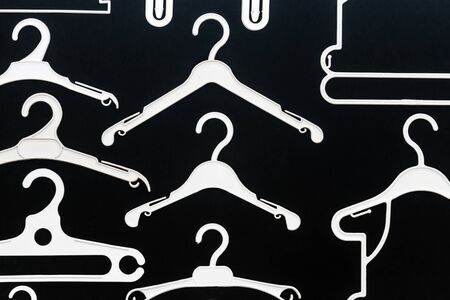 white plastic hanger on a black backgroundの写真素材