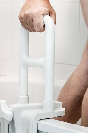 hand holding handrail for the disabled and the elder in the bathroomの写真素材