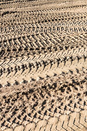 tracks on the sand from the wheels and tracks of a tank, tractor, machine or bulldozerの写真素材