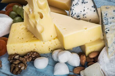 assorted cheeses, soft, hard, rennet and brine with fruits, nuts and dried fruitsの写真素材
