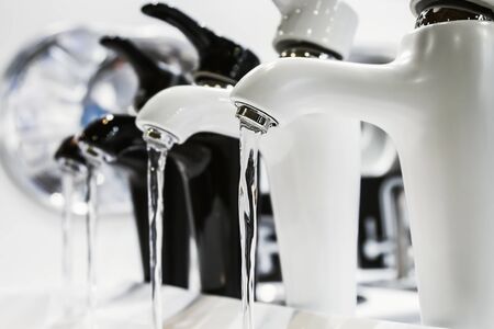 taps with running water are on the shop window. The contrast of black and whiteの写真素材
