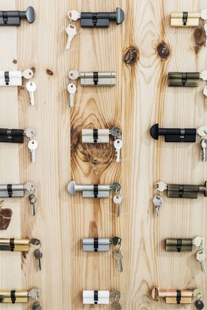 samples of modern locks with keys on wooden backgroundの写真素材