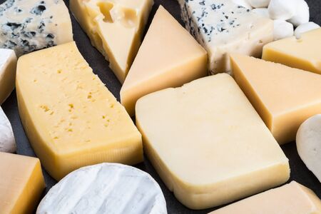 different varieties and types of cheese are on the tableの写真素材