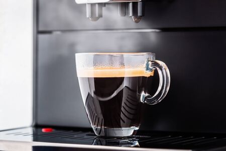 Cup of freshly brewed coffee from the coffee machineの写真素材
