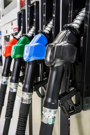 Pump nozzles at the gas station. Shallow depth of field with focus on nozzle blueの写真素材