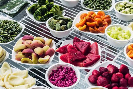fresh-frozen berries, fruits and vegetables in the shop window or in the marketの写真素材