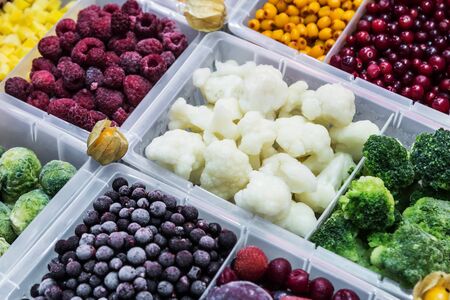 frozen vegetables, fruits and berries in the shop windowの写真素材