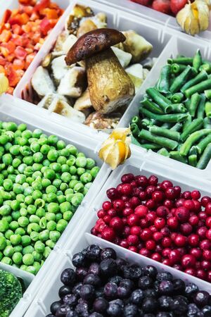 frozen vegetables, fruits and berries in the shop windowの写真素材