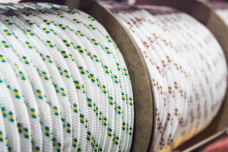 thick rope of different colors in bobbins on the store counterの写真素材