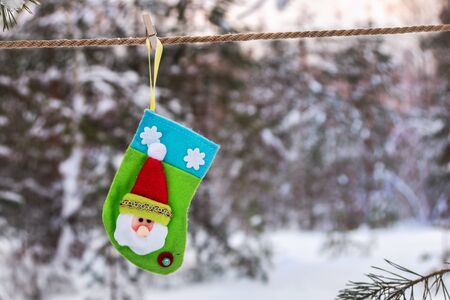 Christmas sock waiting for gifts hanging in the winter forest. Christmas decorationsの写真素材