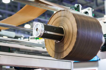 machine for applying the laminated film on wooden surface. Focus on melamine film rollの写真素材