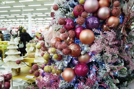 Moscow, Russia-December 7, 2019: Christmas and new year decorations, Christmas trees and toys at the fair in the shopping center "Tvoy dom". Shoppers make Christmas and new year purchasesのeditorial素材