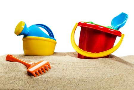  children's toys, bucket, shovel and race on the sea sand isolated on white backgroundの写真素材