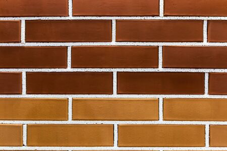 imitation of brickwork from different colors of bricks in a construction store or exhibition. The background of bricksの写真素材