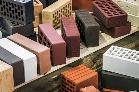 clinker, silicate, ceramic and other types of bricks of different colors. The background is of a different brickの写真素材