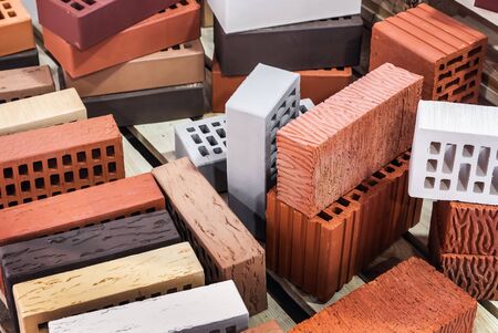 clinker, silicate, ceramic and other types of bricks of different colors. The background is of a different brickの写真素材