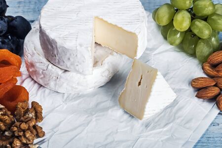 delicious brie cheese with grapes, nuts and baguetteの写真素材