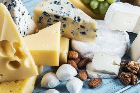 assortment of various cheeses with grapes, nuts and baguette. Cheese plateの写真素材
