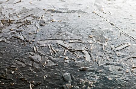 background from the structure of the frozen ice of a winter lake or pond.の写真素材