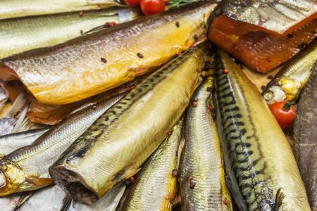 fish smoked mackerel and herring on store counter or fish marketの写真素材