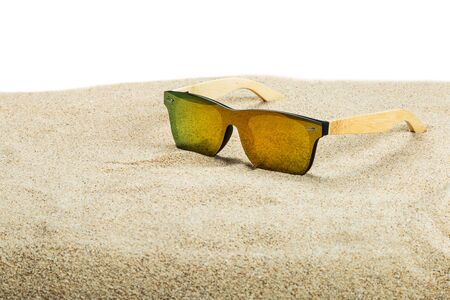 sunglasses with blue glasses on the sand in the desert isolated on a white background. Text deleteの写真素材